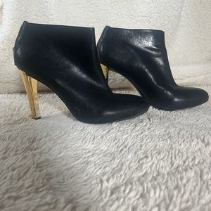 Tory Burch booties black with gold heel.